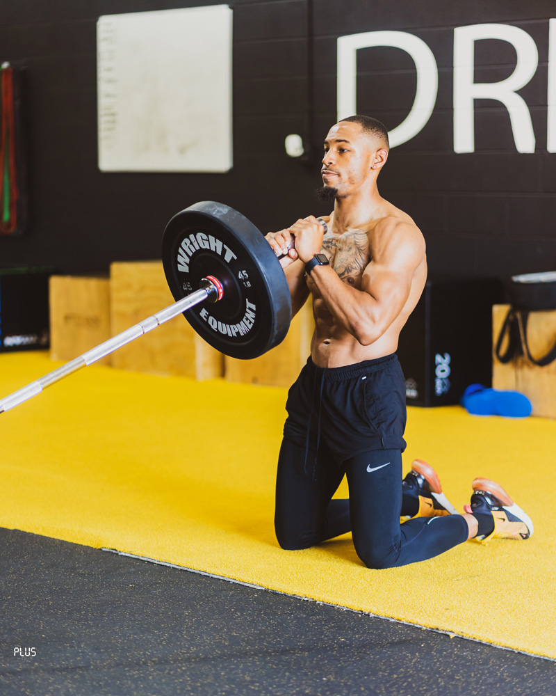 A picture of the coach lifting weights